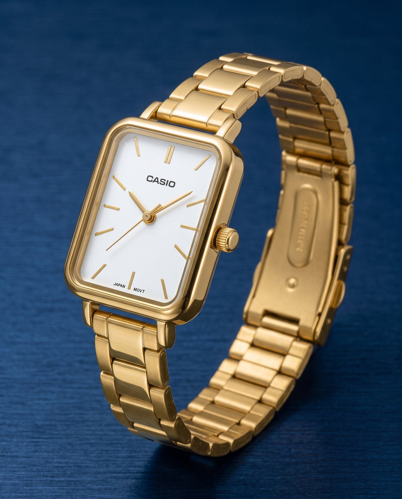 women's gold wristwatch on a blue surface